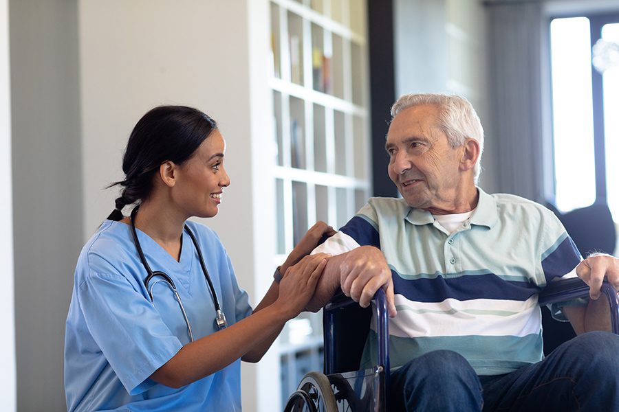 Business Insurance - Nurse Helping Senior in Wheelchair